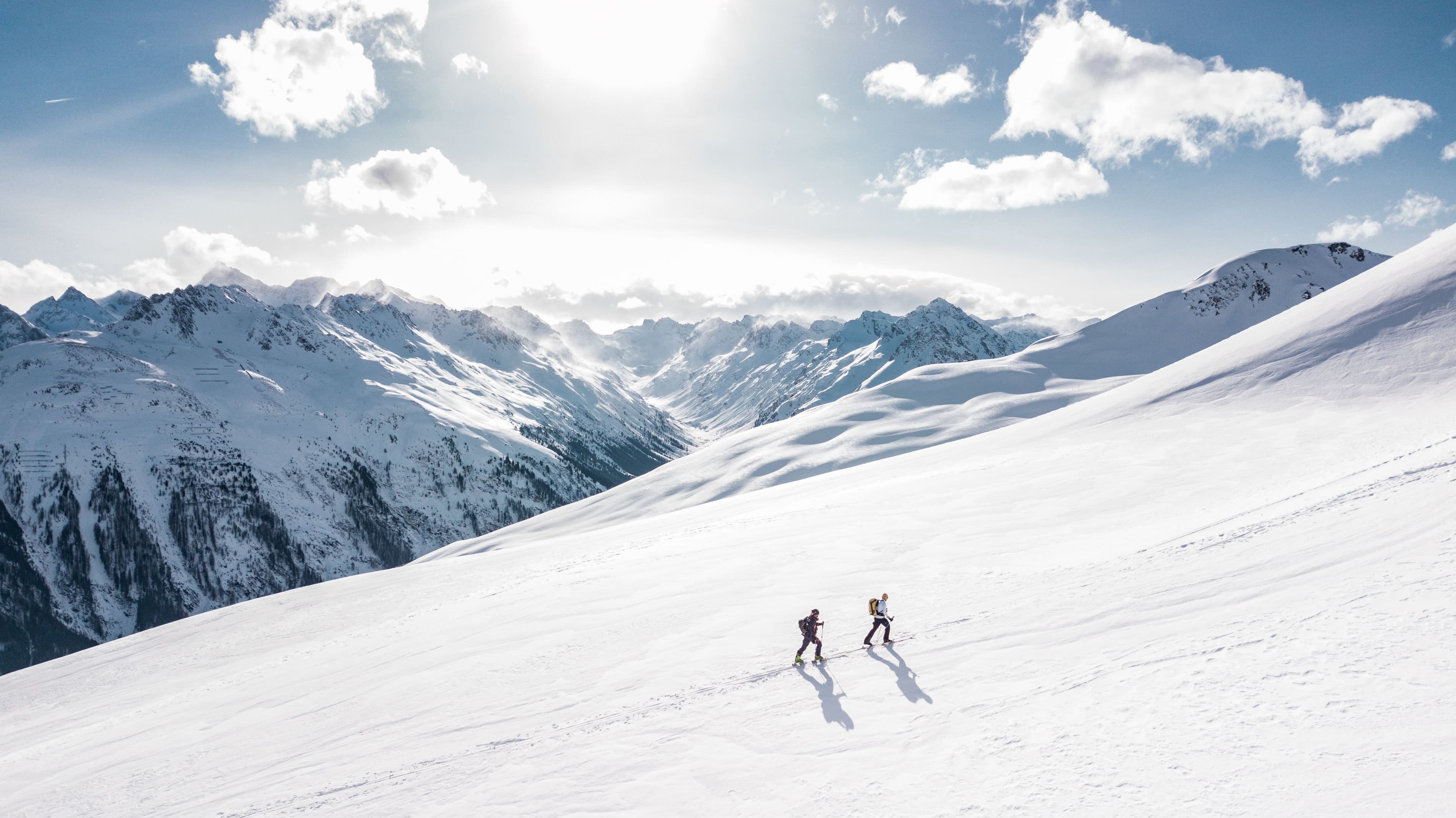 Skiers on a sunny alpine slope